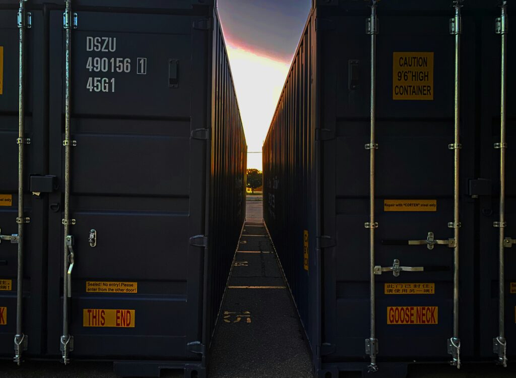 Two containers are standing side by side.